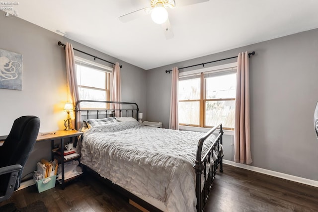 bedroom with multiple windows, dark hardwood / wood-style floors, and ceiling fan