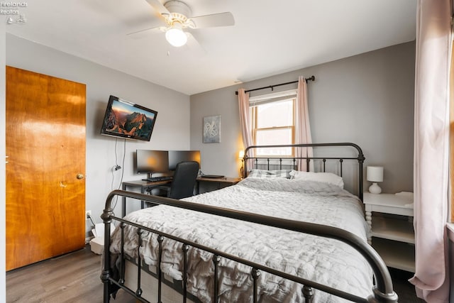 bedroom with ceiling fan and wood-type flooring