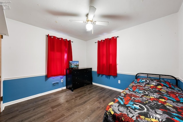 bedroom with ceiling fan and dark wood-type flooring