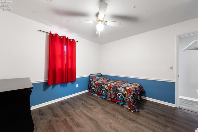 bedroom with dark hardwood / wood-style flooring and ceiling fan