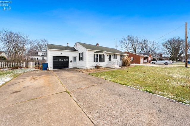 single story home with a front yard and a garage