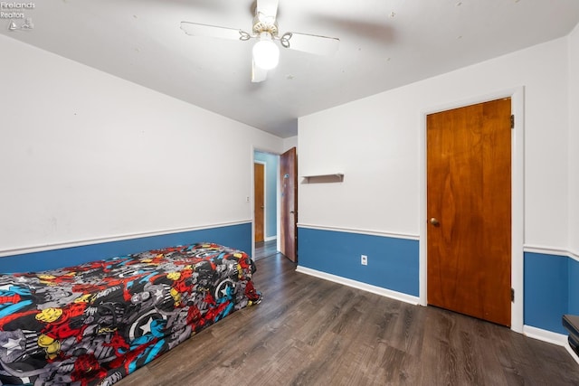 bedroom featuring ceiling fan and dark hardwood / wood-style flooring