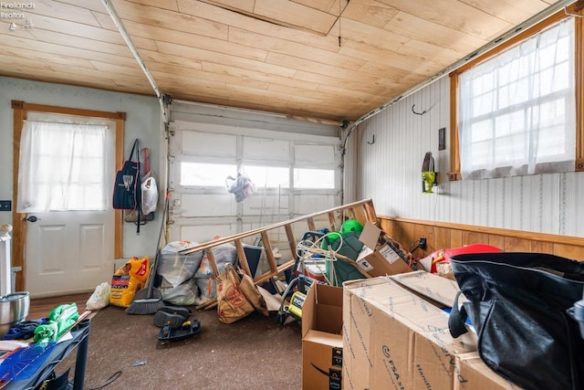 garage with wood ceiling and wooden walls