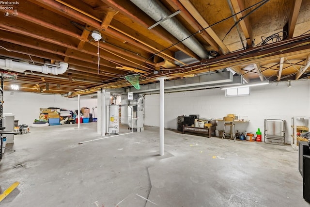 basement with gas water heater and heating unit