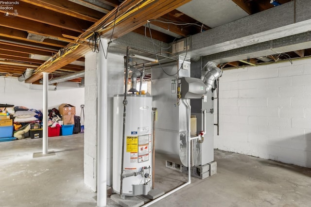 basement featuring gas water heater and heating unit