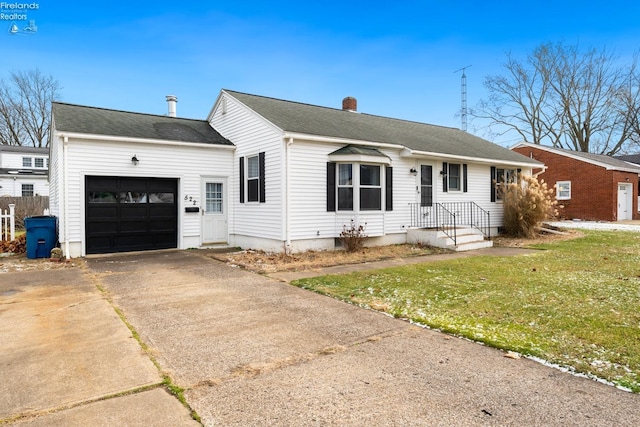 ranch-style house with a garage and a front lawn