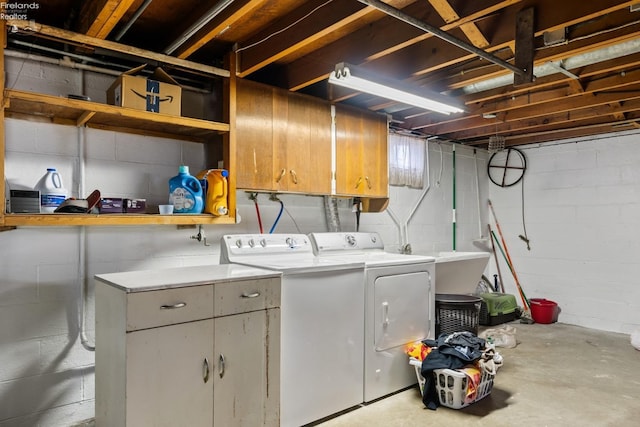 clothes washing area with separate washer and dryer