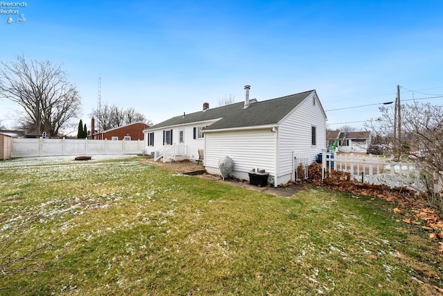 rear view of house featuring a yard