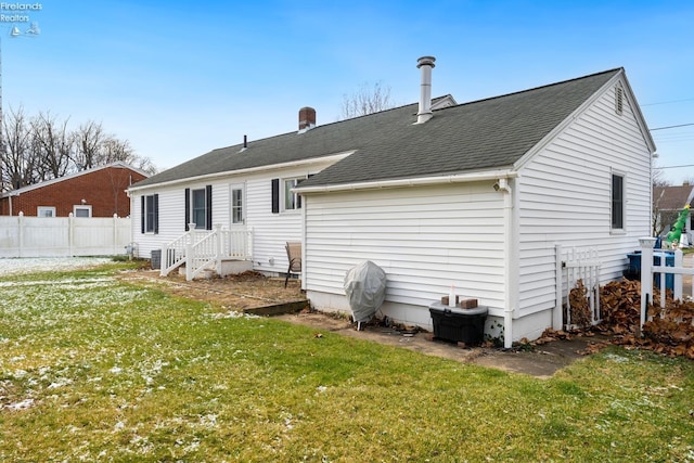 rear view of property with a lawn