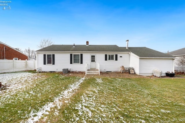 rear view of property with a yard and cooling unit