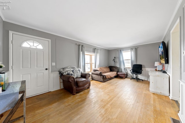 living room featuring light hardwood / wood-style flooring and ornamental molding