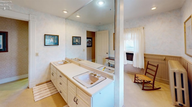 bathroom with radiator and vanity