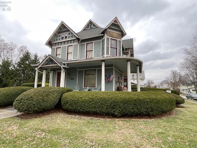 victorian-style house with covered porch and a front yard