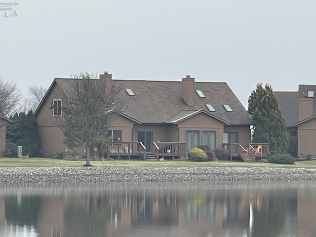 back of house featuring a water view