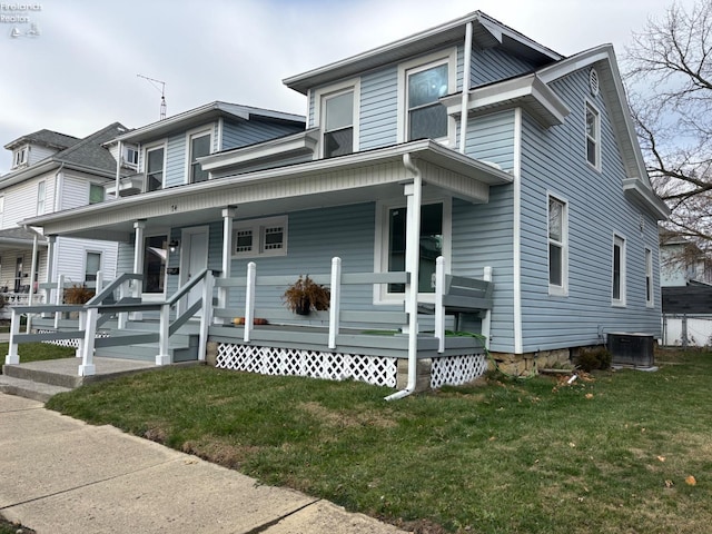 view of front facade with a front yard, a porch, and cooling unit