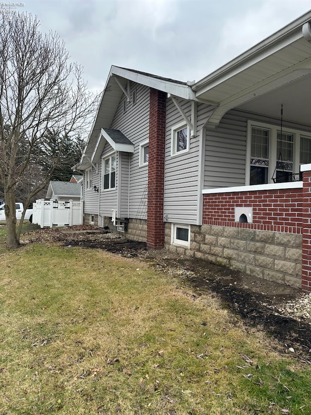 view of side of home featuring a lawn