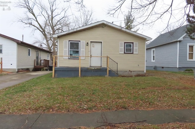 bungalow-style home with a front lawn