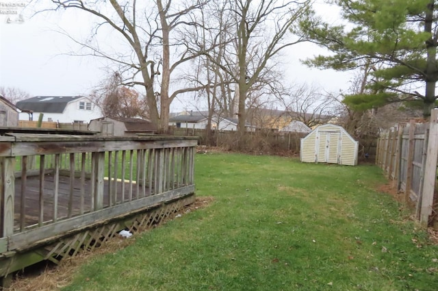 view of yard with a storage shed and a wooden deck