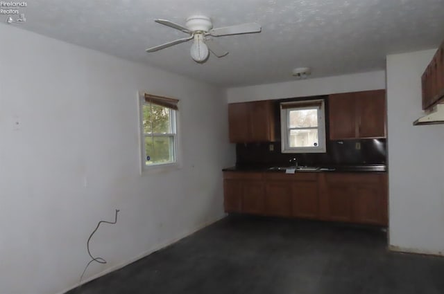 kitchen featuring ceiling fan and sink