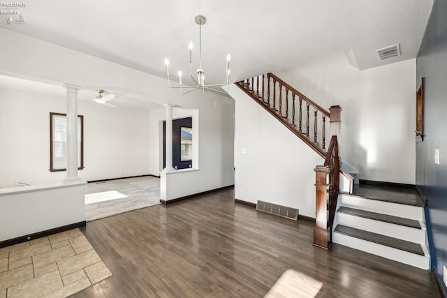 interior space with wood-type flooring, decorative columns, and a notable chandelier