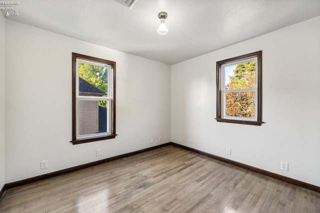 spare room featuring light hardwood / wood-style flooring