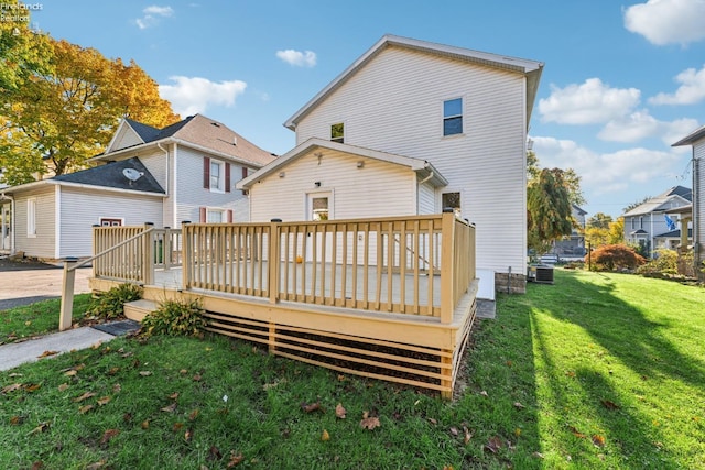 rear view of house featuring a yard and a wooden deck