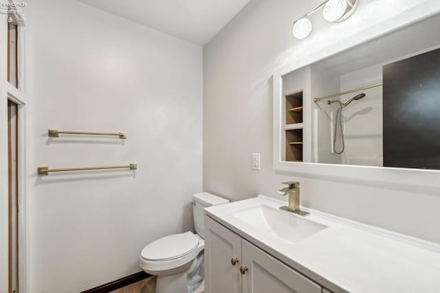 bathroom with vanity, toilet, and walk in shower