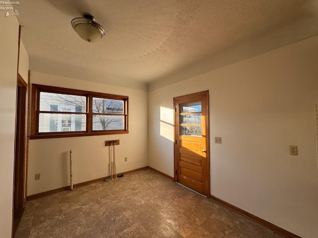 spare room featuring a textured ceiling