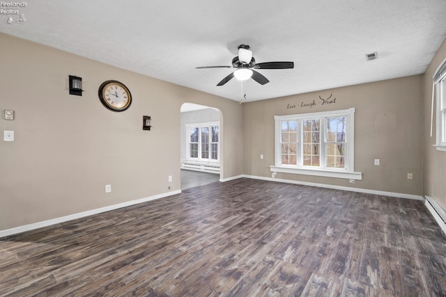 spare room with a textured ceiling, ceiling fan, and dark hardwood / wood-style floors