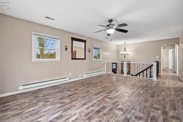 unfurnished room with wood-type flooring, ceiling fan with notable chandelier, and a baseboard radiator