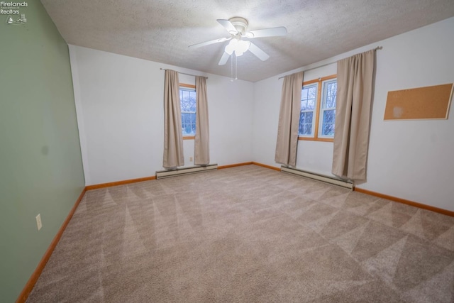 carpeted empty room with ceiling fan, a textured ceiling, and a baseboard heating unit