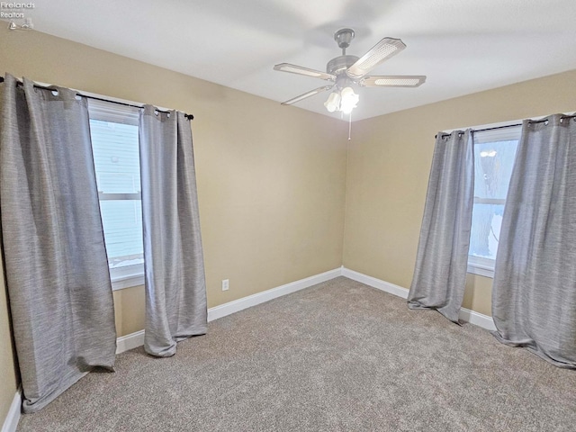 spare room with ceiling fan and carpet floors