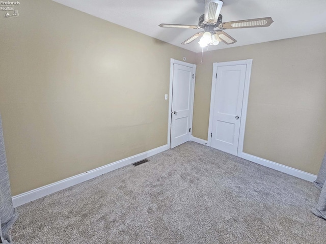 carpeted empty room featuring ceiling fan