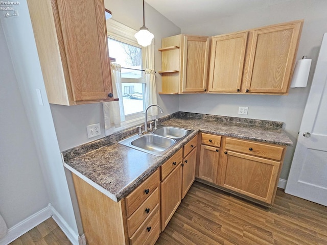 kitchen with pendant lighting, dark hardwood / wood-style floors, and sink