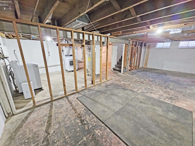 basement with gas water heater and washer / dryer