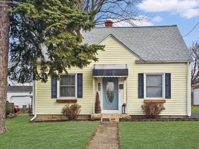 bungalow-style home featuring a front lawn