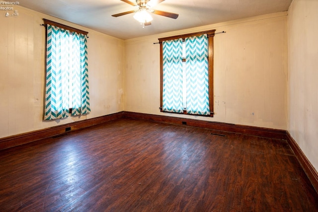 empty room with hardwood / wood-style flooring and ceiling fan