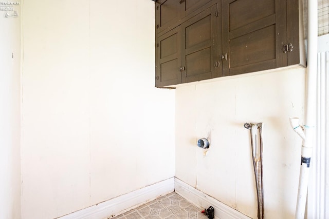 laundry area featuring cabinets