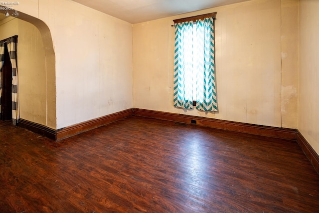 unfurnished room featuring dark hardwood / wood-style flooring