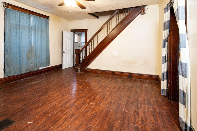 interior space with dark hardwood / wood-style floors, ceiling fan, and a textured ceiling