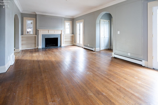 unfurnished living room featuring baseboard heating, crown molding, and wood-type flooring