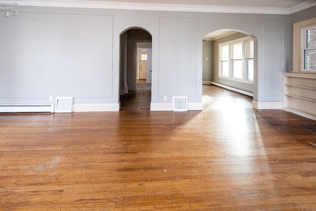 unfurnished room with baseboard heating, built in shelves, crown molding, and hardwood / wood-style floors