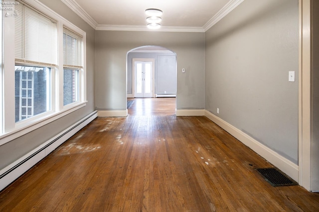 unfurnished room featuring dark hardwood / wood-style flooring, a baseboard radiator, and plenty of natural light