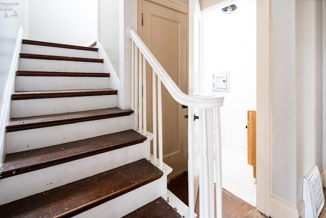 stairs with hardwood / wood-style flooring