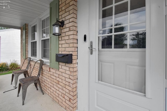 view of exterior entry with covered porch