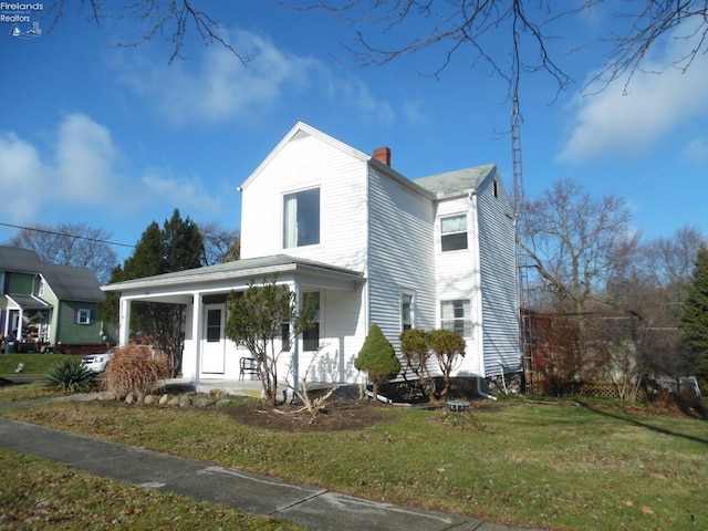 view of front of home featuring a front yard and covered porch