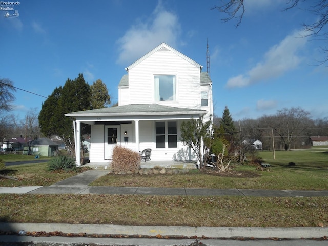 view of front of home with a porch and a front yard