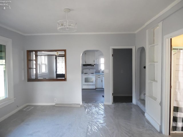 unfurnished living room featuring a chandelier, crown molding, and a healthy amount of sunlight