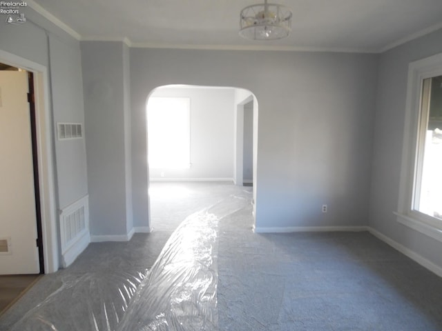 carpeted spare room with ornamental molding