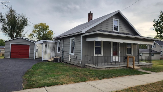 bungalow-style home with central AC, an outdoor structure, a front lawn, covered porch, and a garage